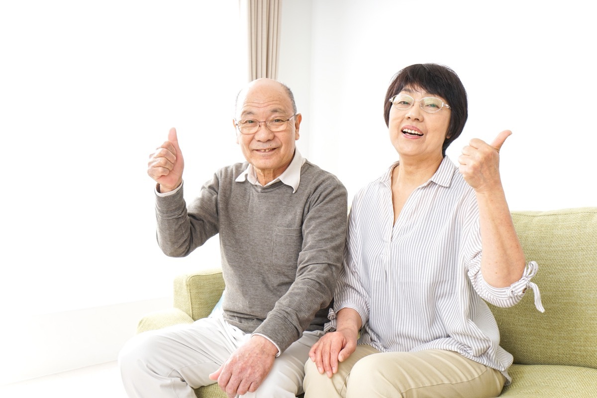 Older couple giving thumbs up